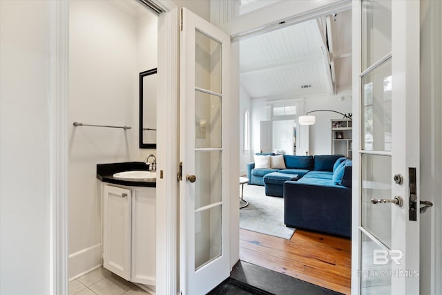 bathroom featuring beamed ceiling, vanity, and tile patterned flooring