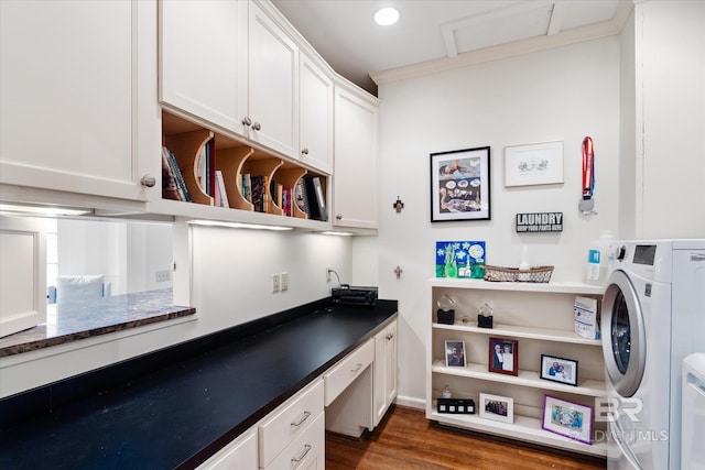 clothes washing area with crown molding, dark wood-type flooring, and cabinets