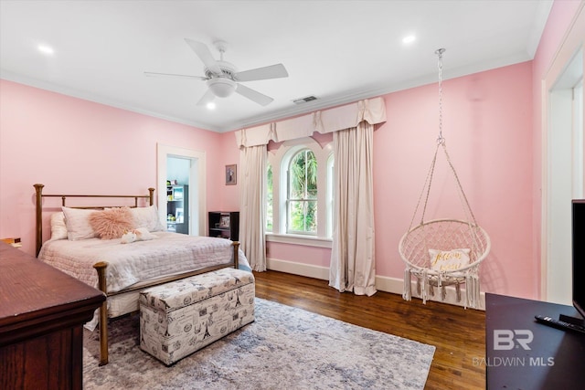 bedroom with ornamental molding, dark hardwood / wood-style floors, and ceiling fan