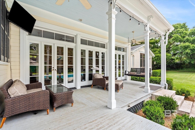 wooden terrace with an outdoor hangout area, french doors, and ceiling fan