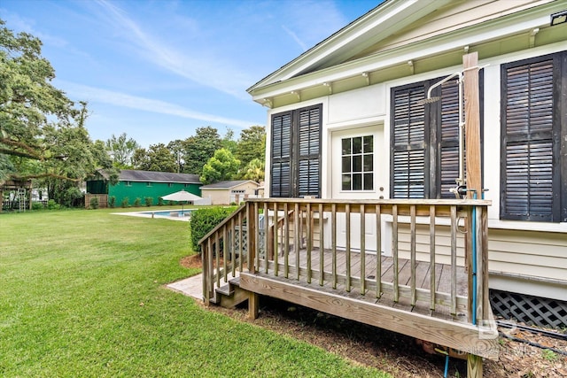 wooden terrace with a swimming pool and a lawn