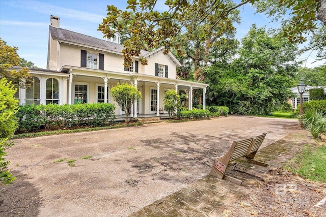 farmhouse inspired home with a porch