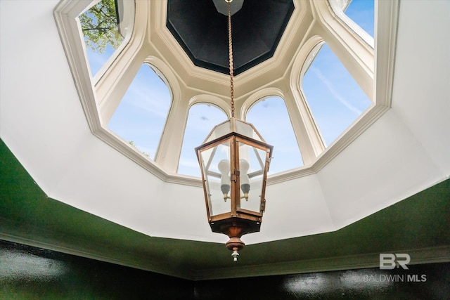 interior details featuring crown molding and a chandelier