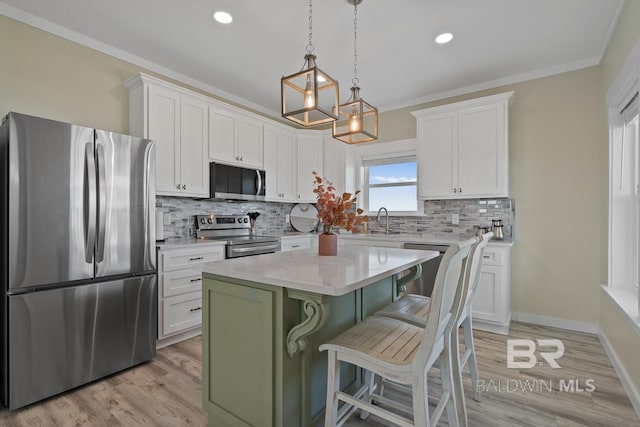 kitchen with white cabinetry, a center island, and stainless steel appliances