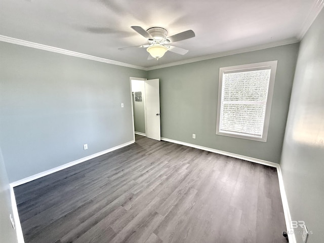 empty room featuring a ceiling fan, crown molding, baseboards, and wood finished floors