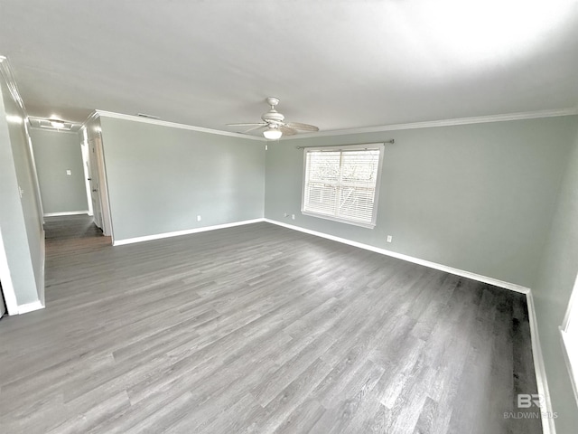 unfurnished room featuring baseboards, wood finished floors, a ceiling fan, and crown molding