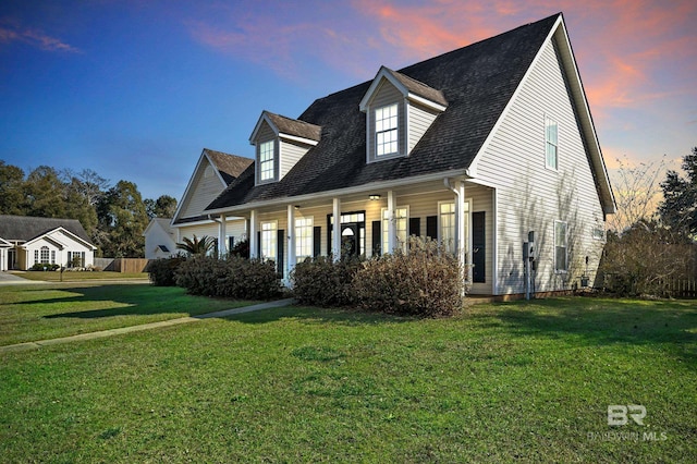 view of front of house with a front yard and a porch