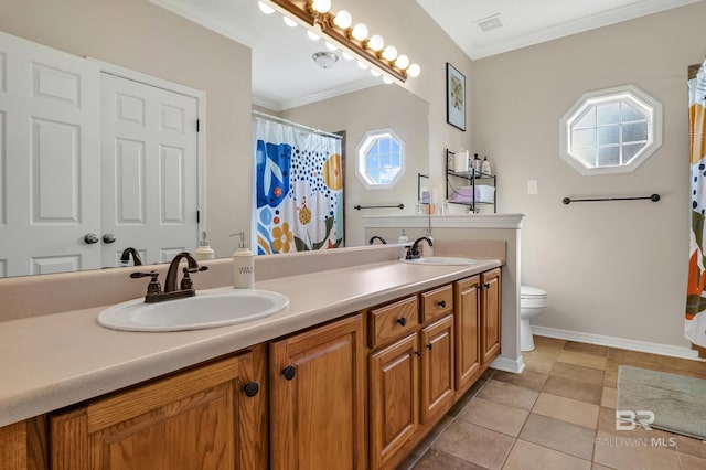 full bath with a sink, toilet, ornamental molding, and double vanity