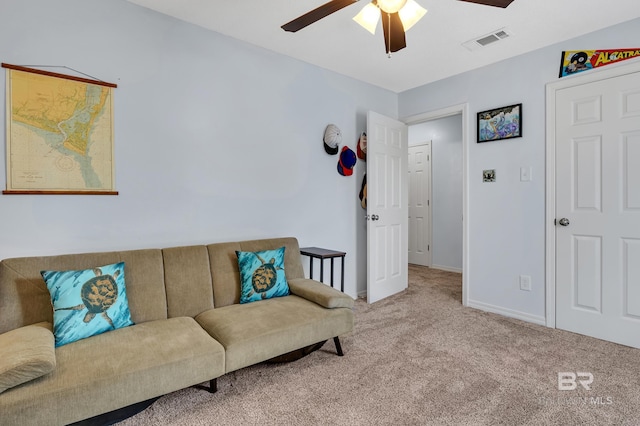 living area featuring visible vents, baseboards, a ceiling fan, and carpet flooring