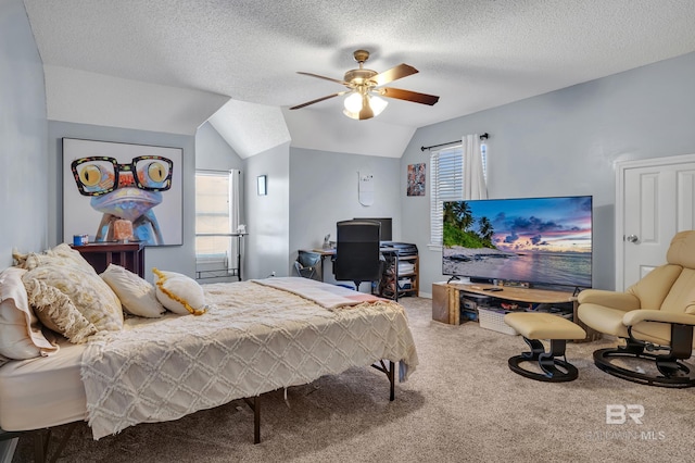 bedroom with ceiling fan, a textured ceiling, lofted ceiling, and carpet