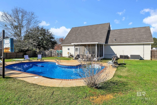 view of pool featuring a patio area, a lawn, a fenced backyard, and a sunroom