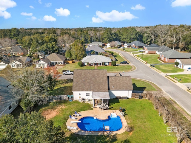 drone / aerial view featuring a residential view and a wooded view