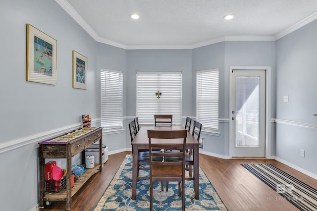 dining space with wood finished floors, baseboards, and a wealth of natural light