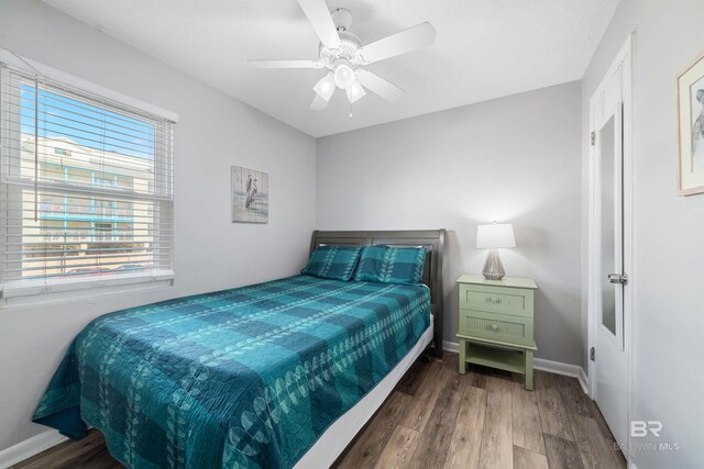 bedroom with wood-type flooring and ceiling fan