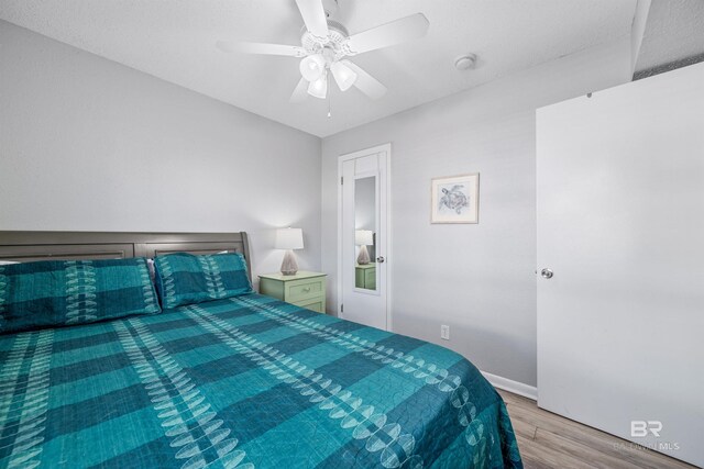 bedroom with light wood-type flooring and ceiling fan