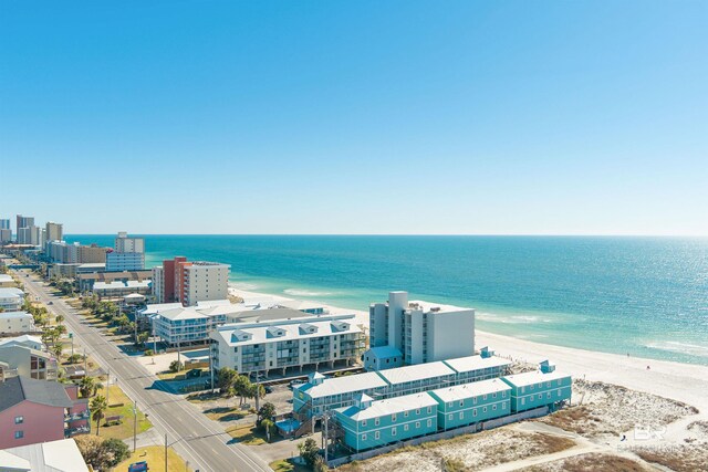 birds eye view of property with a view of the beach and a water view