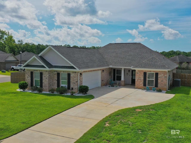 view of front of house featuring central AC, a garage, and a front lawn