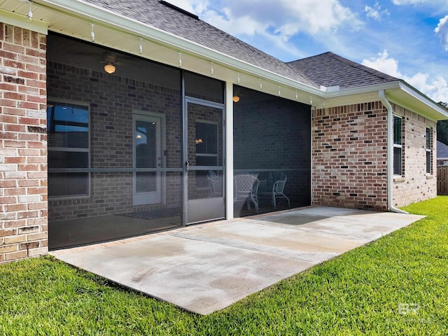 property entrance featuring a patio and a lawn