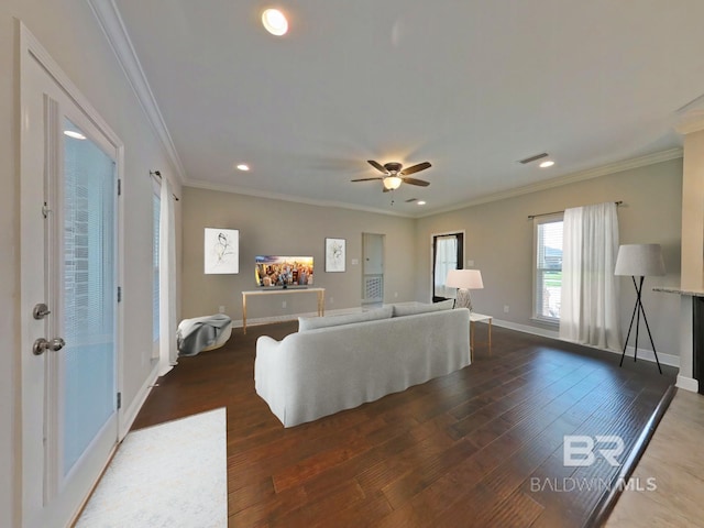 living room with ornamental molding, dark hardwood / wood-style floors, and ceiling fan