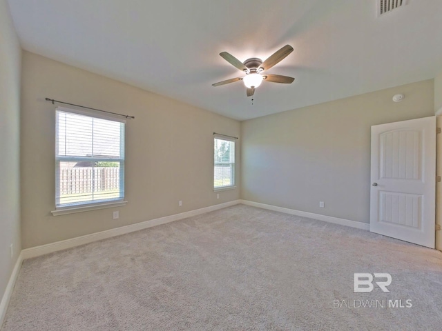 carpeted spare room with ceiling fan