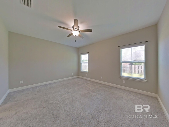 empty room featuring light carpet and ceiling fan