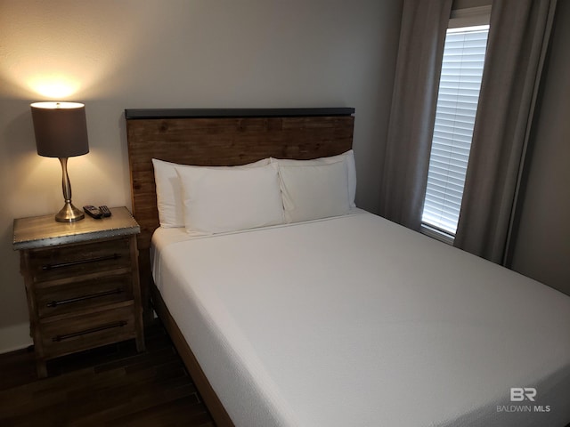 bedroom with dark wood finished floors