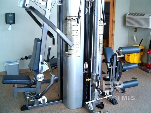 workout area featuring a wall mounted air conditioner
