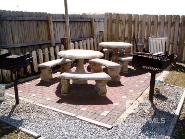 view of patio featuring outdoor dining area and a fenced backyard