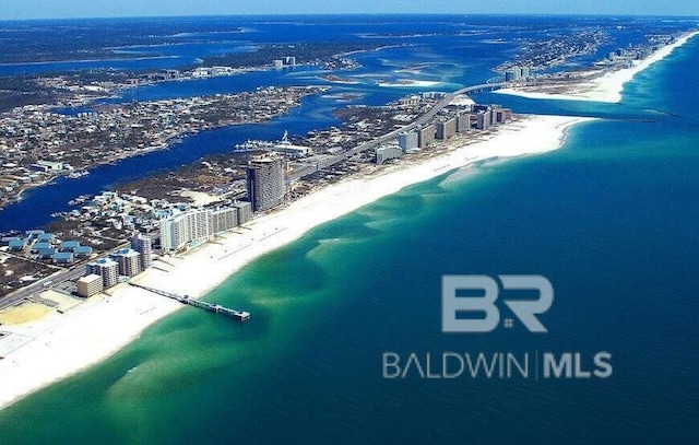 birds eye view of property with a view of city, a beach view, and a water view