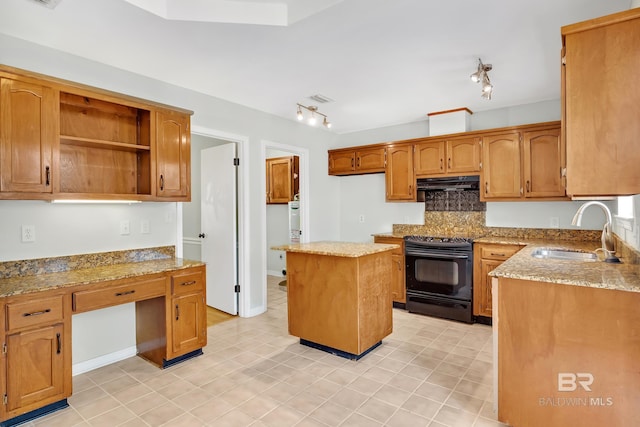 kitchen with black electric range oven, a sink, light stone counters, under cabinet range hood, and decorative backsplash