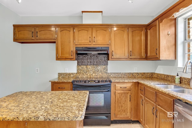 kitchen with under cabinet range hood, dishwasher, black electric range, brown cabinetry, and a sink