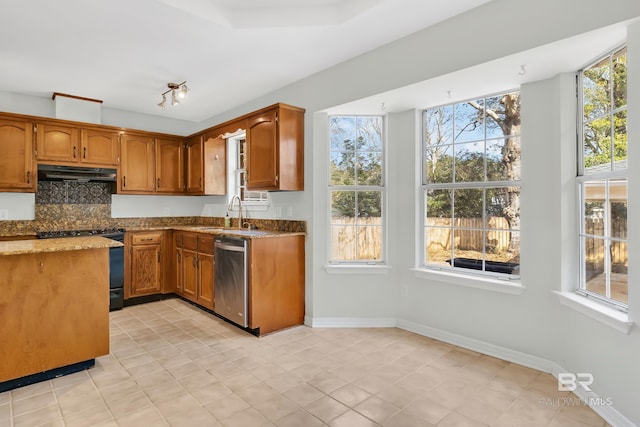 kitchen featuring black range with electric stovetop, light stone countertops, under cabinet range hood, stainless steel dishwasher, and a sink