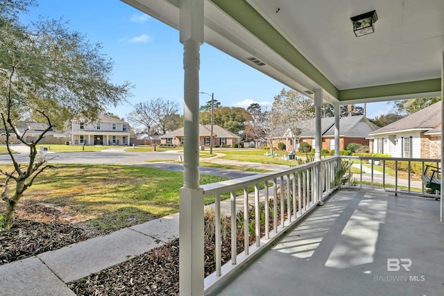 view of patio featuring a porch and a residential view