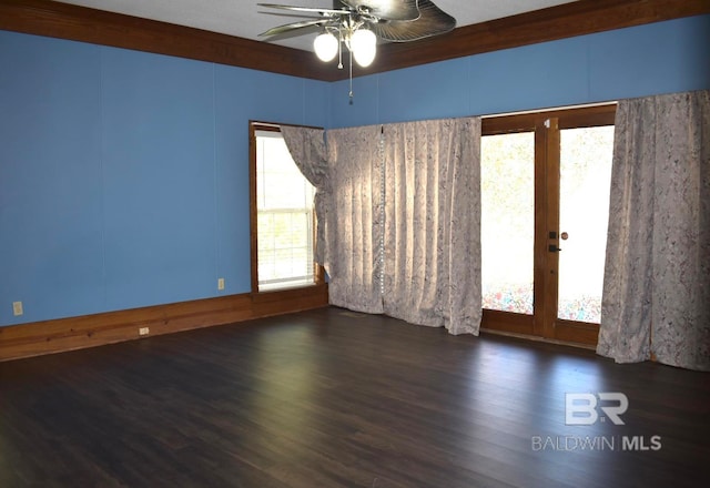 spare room featuring dark wood-type flooring and ceiling fan