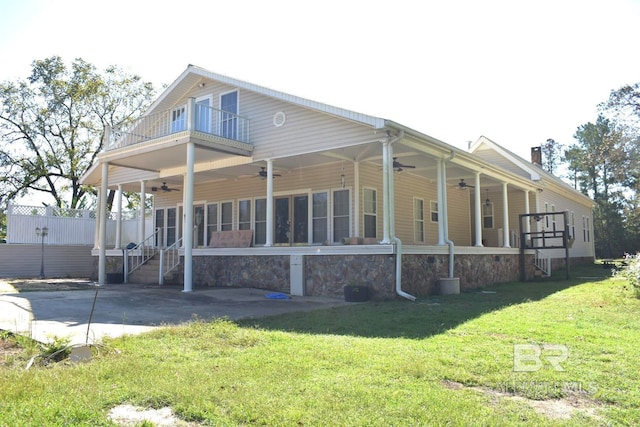 back of property featuring a patio area, a yard, and ceiling fan