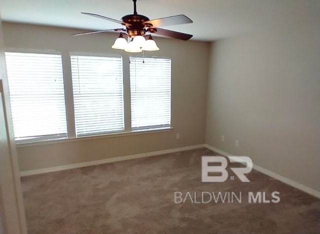 empty room with ceiling fan and carpet flooring