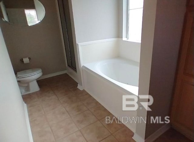 bathroom with shower with separate bathtub, toilet, and tile patterned flooring