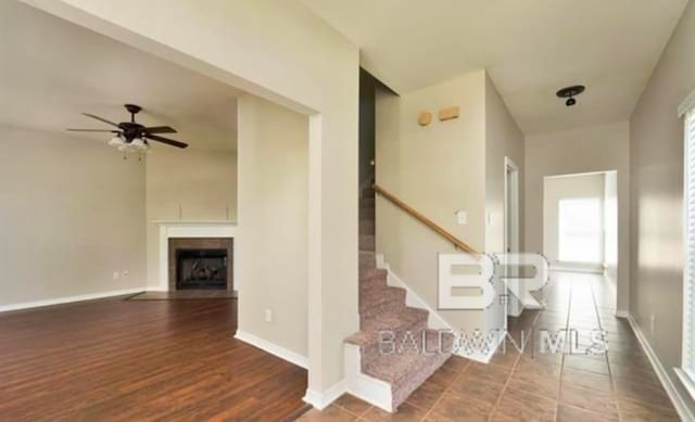 stairway featuring hardwood / wood-style floors and ceiling fan