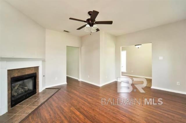 unfurnished living room with ceiling fan, a fireplace, and hardwood / wood-style floors