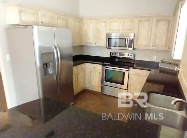 kitchen featuring dark tile patterned flooring and stainless steel appliances