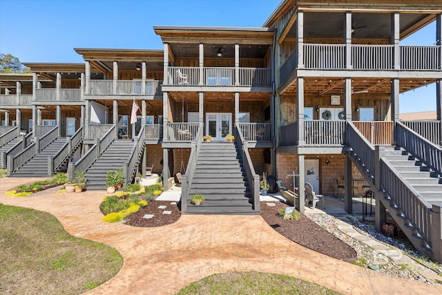 view of front of house with stairway, a patio area, and a ceiling fan