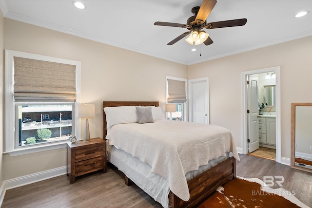 bedroom with crown molding, recessed lighting, ensuite bathroom, wood finished floors, and baseboards