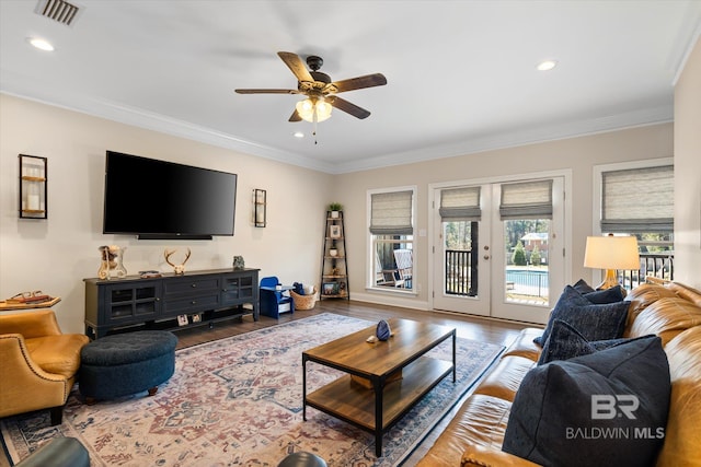 living area with ornamental molding, french doors, visible vents, and wood finished floors