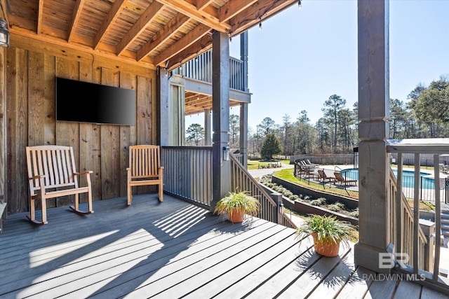 wooden terrace with a fenced in pool