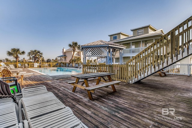 deck with a community pool and a gazebo