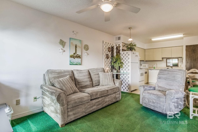 carpeted living room with a textured ceiling and ceiling fan