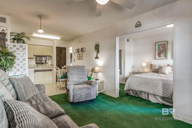 carpeted bedroom with sink, a textured ceiling, and ceiling fan