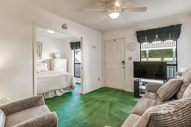 bedroom with a textured ceiling, carpet flooring, a closet, and ceiling fan