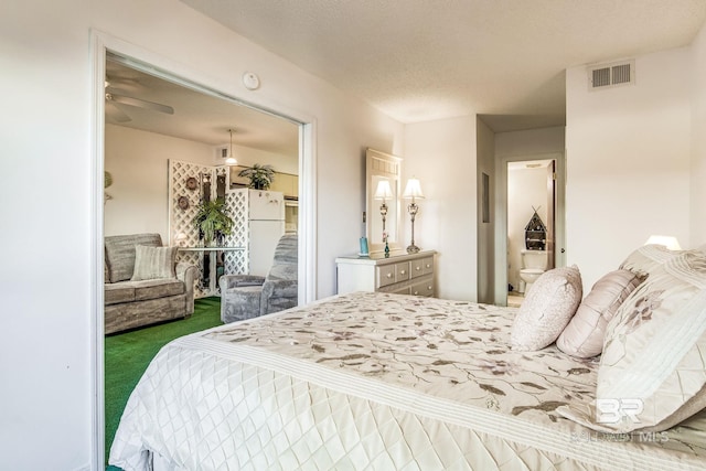 carpeted bedroom with a textured ceiling