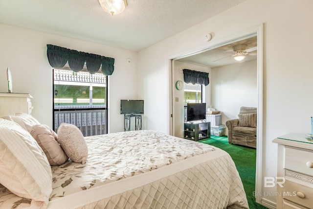 carpeted bedroom featuring ceiling fan and a textured ceiling